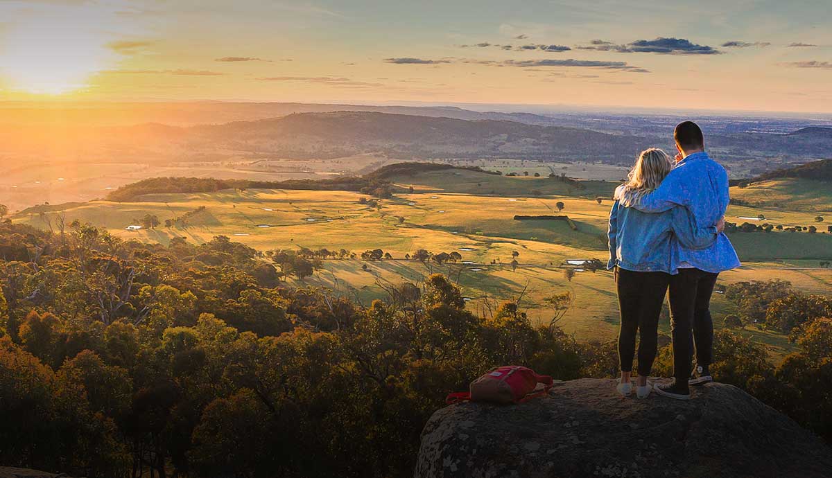Couple at Mount Wombat lookout at sunrise